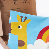 A close up image of the Frugi organic cotton kids' height chart in its cardboard gift box, showing it folded with the top of a giraffe's head illustration. 