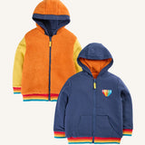 Frugi Helston reversible hoodie jacket. One side is navy cotton with a hello badge design on the chest  with a orange fleece body and yellow sleeves on the other.