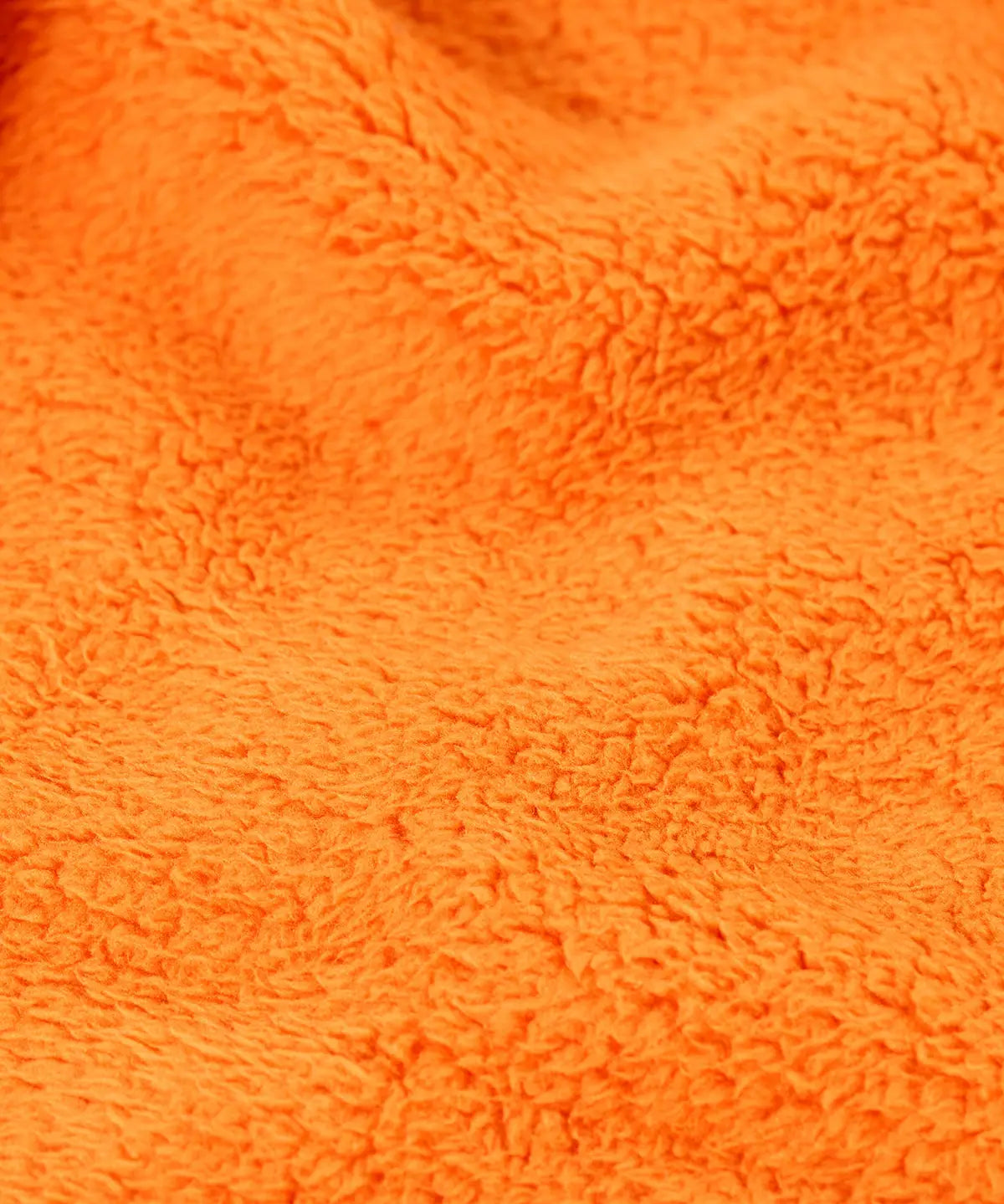 Close up of the orange recycled polyester fleece on the Frugi Helston reversible hoodie jacket. One side is navy cotton with a hello badge design on the chest  with a orange fleece body and yellow sleeves on the other.