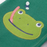 A close up of the frog applique on the knee on the Frugi holly green coloured frog beaver crawlers kids organic ccotton joggers. 