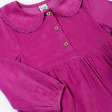 A close up of the Frugi kids holly dress in damson flowers showing the corduroy and frilled collar detail with button fasteners on bright purple organic cotton fabric.