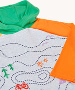 A close up of the front of the Frugi Compass Organic Cotton Hooded Top showing the orange sleeve and green hood. 