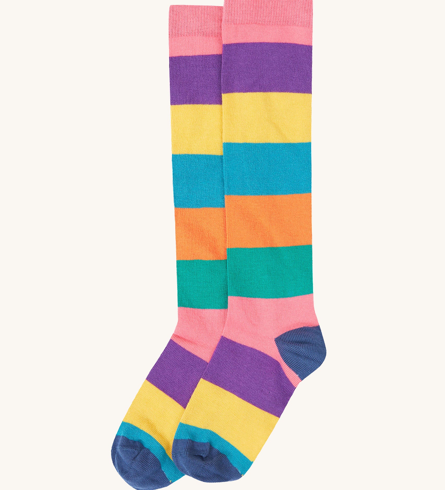 A close up of the pastel inspired striped knee high sock from the Frugi kids hygge high knee socks in patchwork 2 pack. Showing the striped detail on organic cotton fabric.