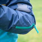 The secret snacks pocket inside the Frugi Snow & Ski Coat - Iguana Colourblock