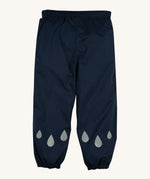 The front of the Frugi Indigo Navy coloured Rain Or Shine waterproof Trousers. The trousers have rain drop shaped reflective patches on the lower leg.
