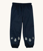 The front of the Frugi Indigo Navy coloured Rain Or Shine waterproof Trousers. The trousers have rain drop shaped reflective patches on the lower leg.