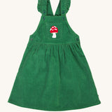 Frugi kids isla dugaree dress in holly green/mushroom available at Babipur. A 100% GOTS organic cotton dungaree dress in a green corduroy colour. Features a mushroom embroidery on a small front pocket, button fasteners and frilled shoulder straps.