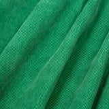 A close up of the frugi kids isla dugaree dress in holly green/mushroom showing the corduroy detail on green organic cotton fabric.