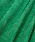 A close up of the frugi kids isla dugaree dress in holly green/mushroom showing the corduroy detail on green organic cotton fabric.