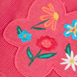 Close up of the flowers embroidery on the front of the Frugi Isla pink rose dungaree dress with.