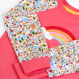 Frugi GOTS 100% organic cotton kids pyjama in pink and white with floral sleeves and fold down cuffs for extender wear