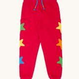 Frugi journey joggers in scarlet red with three stars appliques on each side.