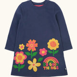 Frugi Kari long sleeved dress in navy with flowers and do good things rainbow slogans along the hemline.