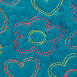 Close up of the floral embroidery on the Frugi Katie quilted cord jacket in boat blue. Flowers and hearts in various colours.
