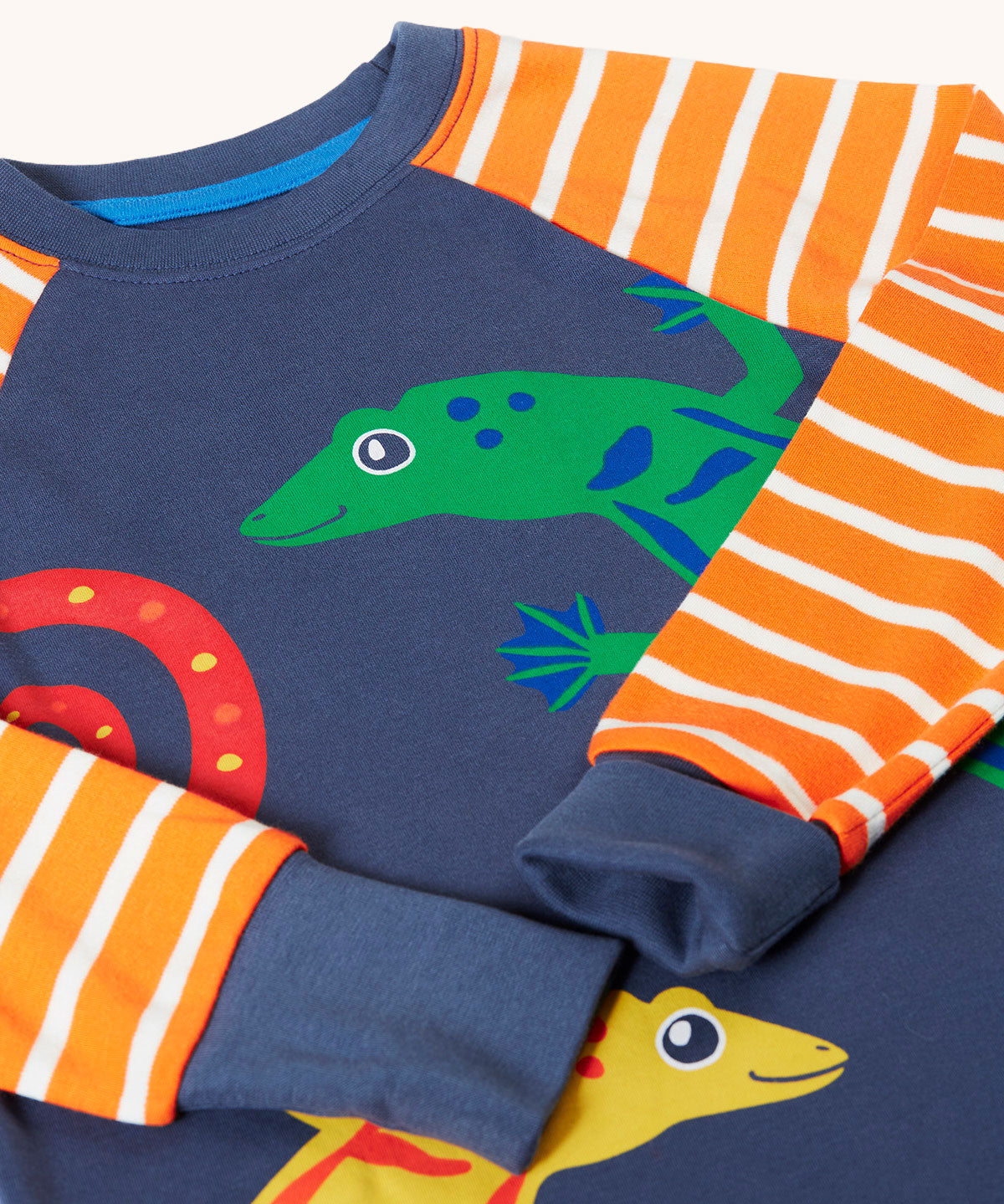 A close up of the long sleeved top from the Frugi geckos breton stripe pyjamas .