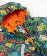 A close up of the Frugi kids be hoppy puddle buster coat showing the multicoloured frogs on navy waterproof material. Features a full length zip and velcro fasteners for a secure fit.