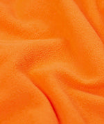 A close up of the orange fleece inside liner on the be hoppy Frugi puddle buster coat for warmth. 