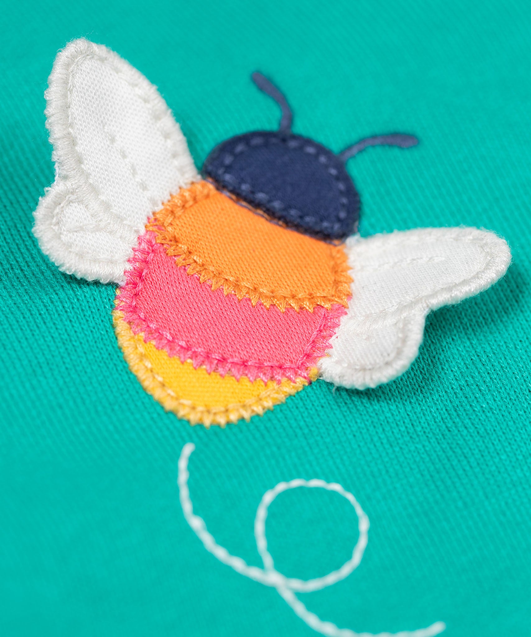 A close up of the Frugi kids carbis hoodie in dragon/bee showing the playful bee appliqué detail on turquoise GOTS organic cotton fabric. 