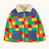 A colorful children's frugi fleece jacket with a rainbow checkered pattern, navy blue collar and pockets, and a cream sherpa lining