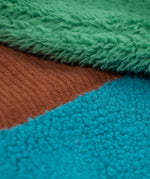 A close up of the Frugi kids braken fleece cord jacket in holly green/hotchpotch showing the ted fleece and cord detail