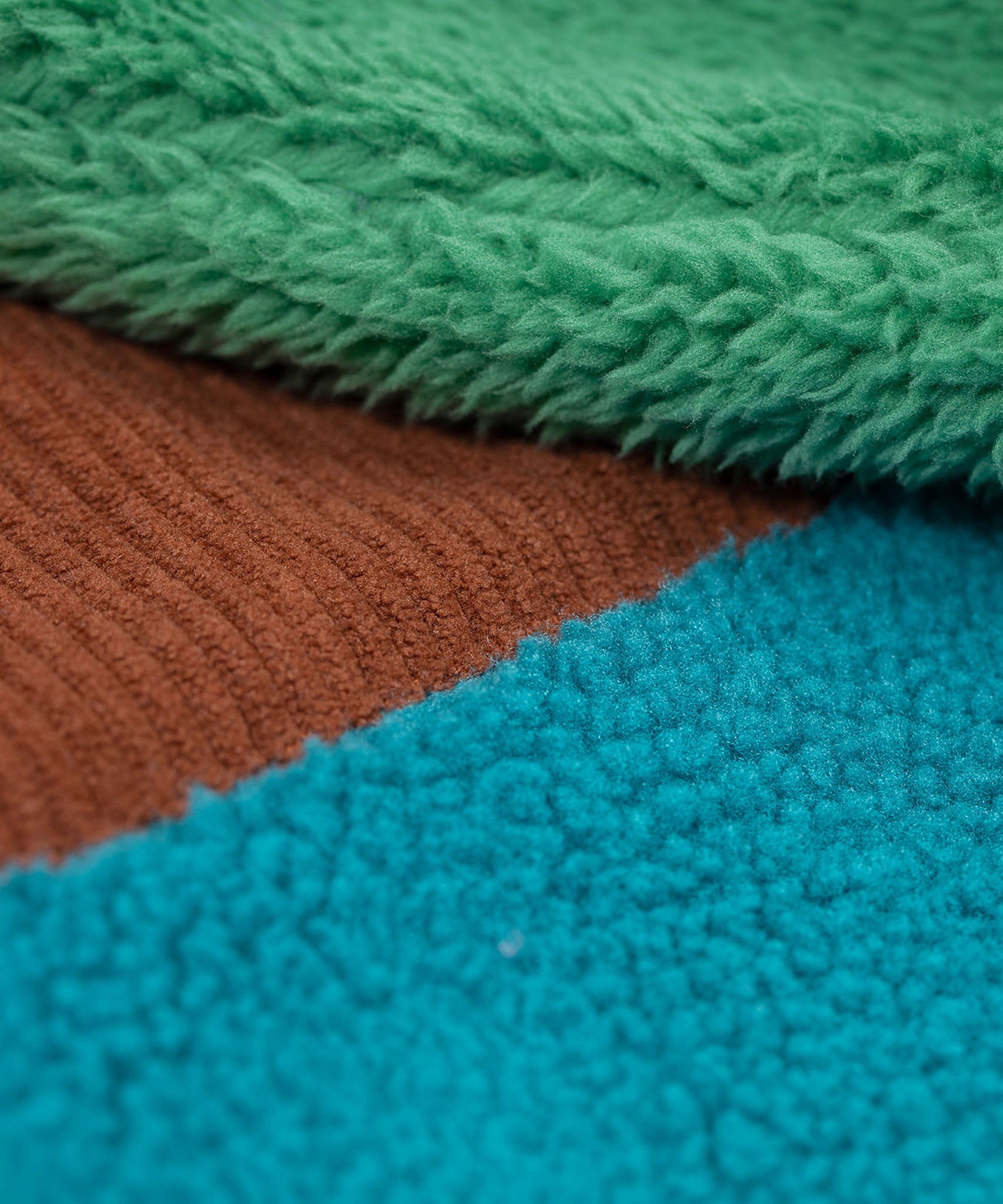 A close up of the Frugi kids braken fleece cord jacket in holly green/hotchpotch showing the ted fleece and cord detail