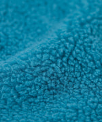 A close up of the Frugi bude boat blue fleece gilet showing the turquoise fleece  detail
