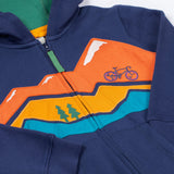 A close up of the Frugi kids carbis hoodie in navy/blue mountain showing the mountainscape applique detail over the full length zip