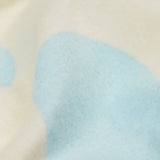 A close up of the Frugi kids cosy flared leggings in super spot showing the brushed fleece inner liner.