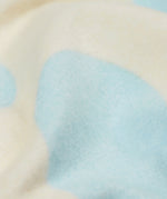 A close up of the Frugi kids cosy flared leggings in super spot showing the brushed fleece inner liner.