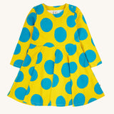 Frugi cosy skater dress in super spot available at Babipur. A 100% GOTS organic cotton skater dress in yellow with long sleeves and bold blue circle prints/ Features popper fasteners on the shoulder.