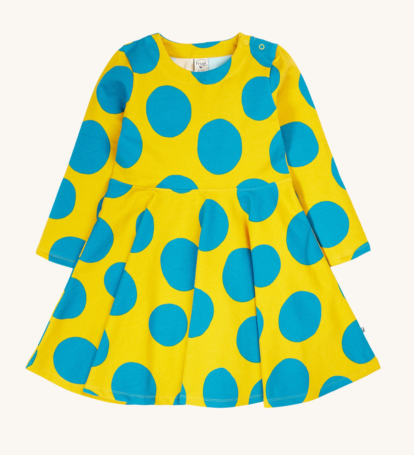 Frugi cosy skater dress in super spot available at Babipur. A 100% GOTS organic cotton skater dress in yellow with long sleeves and bold blue circle prints/ Features popper fasteners on the shoulder.
