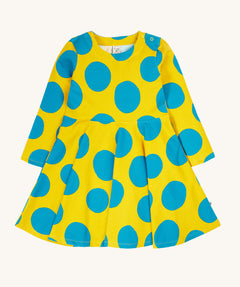 Frugi cosy skater dress in super spot available at Babipur. A 100% GOTS organic cotton skater dress in yellow with long sleeves and bold blue circle prints/ Features popper fasteners on the shoulder.