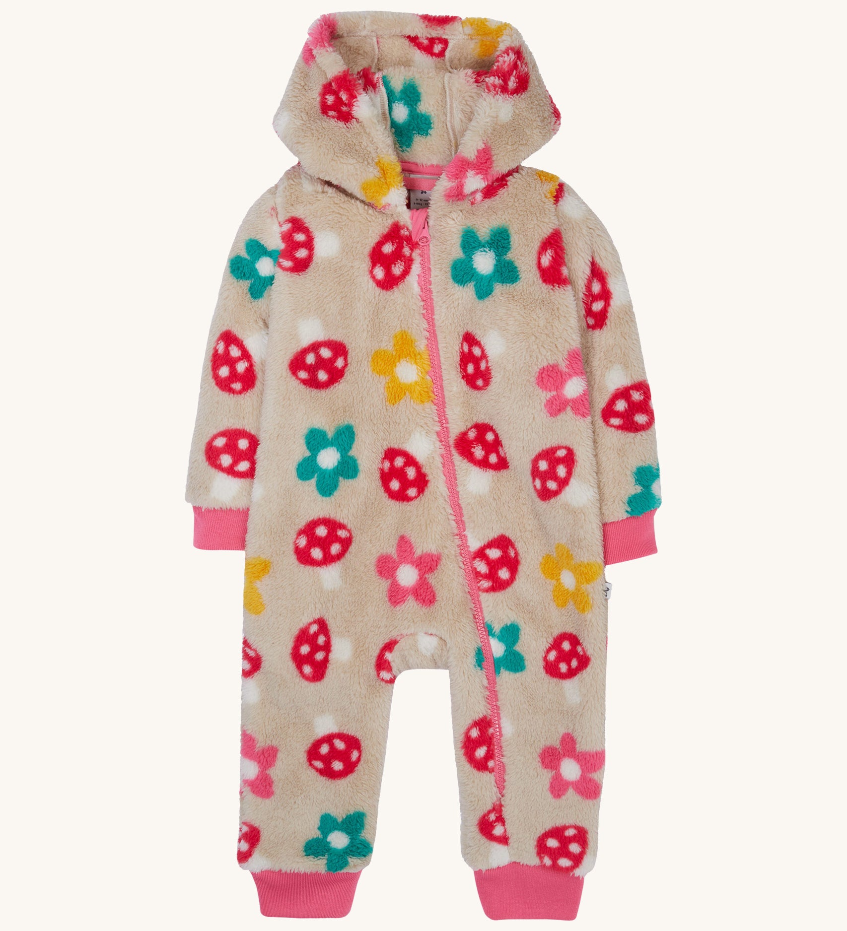 Frugi kids recycled cosy snuggle suit in mushroom fields. A recycled textile all in one suit in a cream colour with a mushroom and flower design. Features a warm cosy hood and a pink trim with matching pink cuffs.