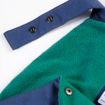 A closer look at the green fleece inner lining and name label on the Frugi Children's Little Waterproof Dungarees - Navy Blue