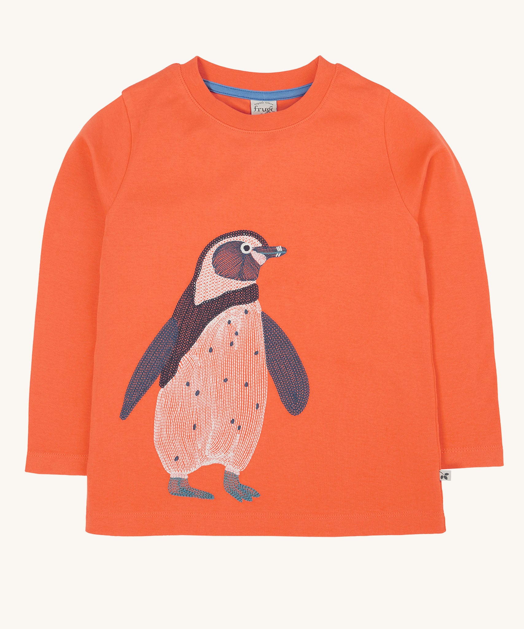 Frugi kids emroidered adventure top in salamander/penguin available at Babipur. A GOTS organic cotton top in pastel orange with a cute penguin embroidery on the front.