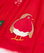 Close up of the robin applique on the  red tulle skirt of the Frugi emmie skater dress.