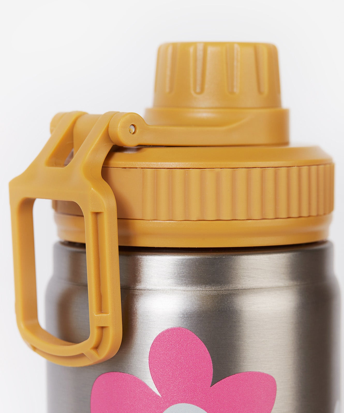 A close up of the Frugi kids Insulated bottle in fun flowers. Showing the yellow cap with loop detail. 