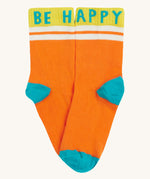 Close up of the Frugi orange sunnie socks. Showing the Be Happy slogan on the ankle cuff. Features a light blue heel and toe contrast panel on orange organic cotton fabric