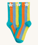 Close up of the Frugi multicoloured stripe sunnie socks. Showing the white stars the striped ankle cuff. Features a blue heel and toe contrast panel on striped organic cotton fabric
