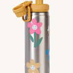 Frugi kids Insulated bottle in fun flowers with the yellow cap opened. A stainless steel bottle with playful flower prints. 