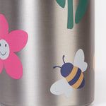 A close up of the Frugi kids Insulated bottle showing a playful bee and flower print on the stainless steel bottle