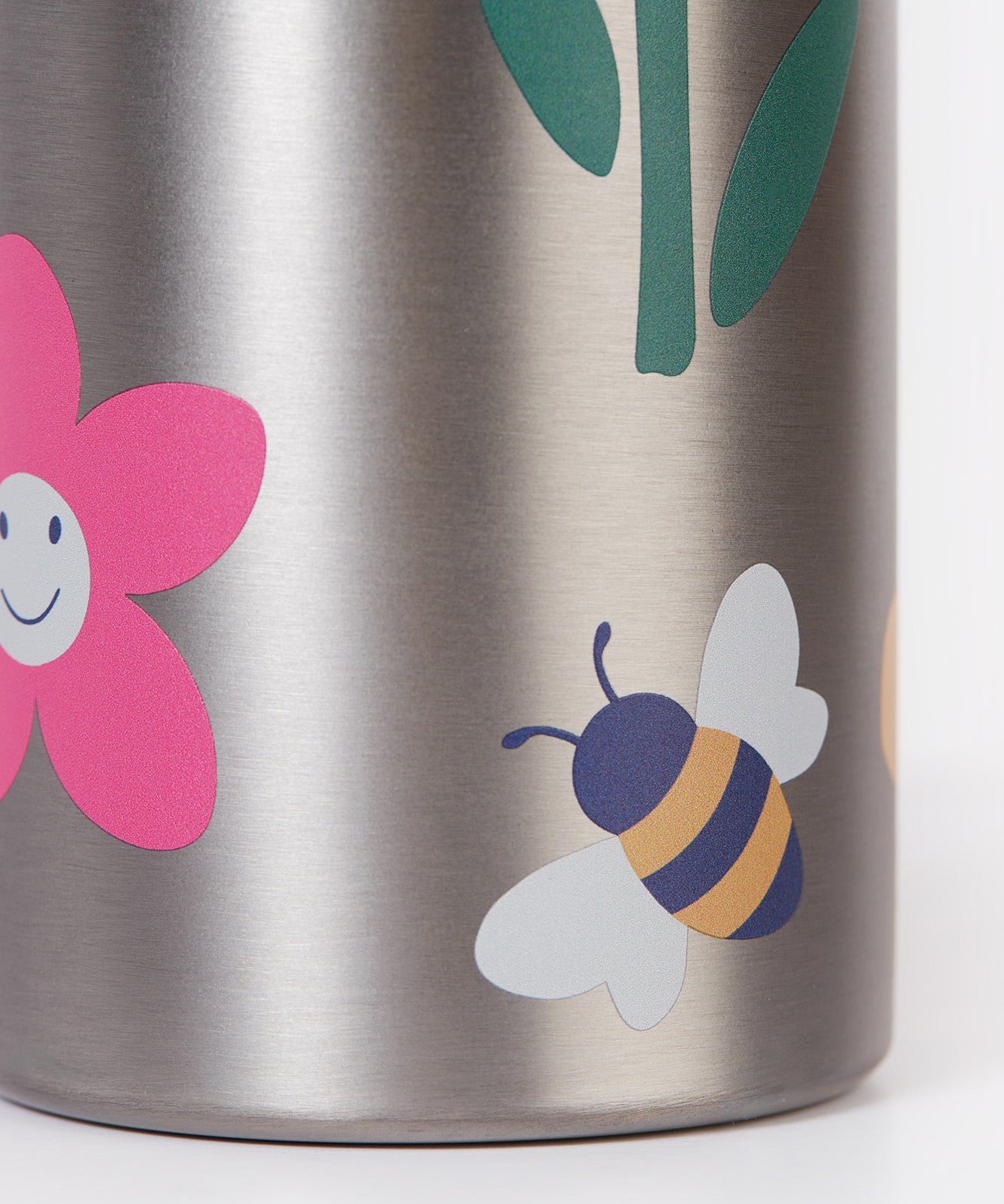 A close up of the Frugi kids Insulated bottle showing a playful bee and flower print on the stainless steel bottle