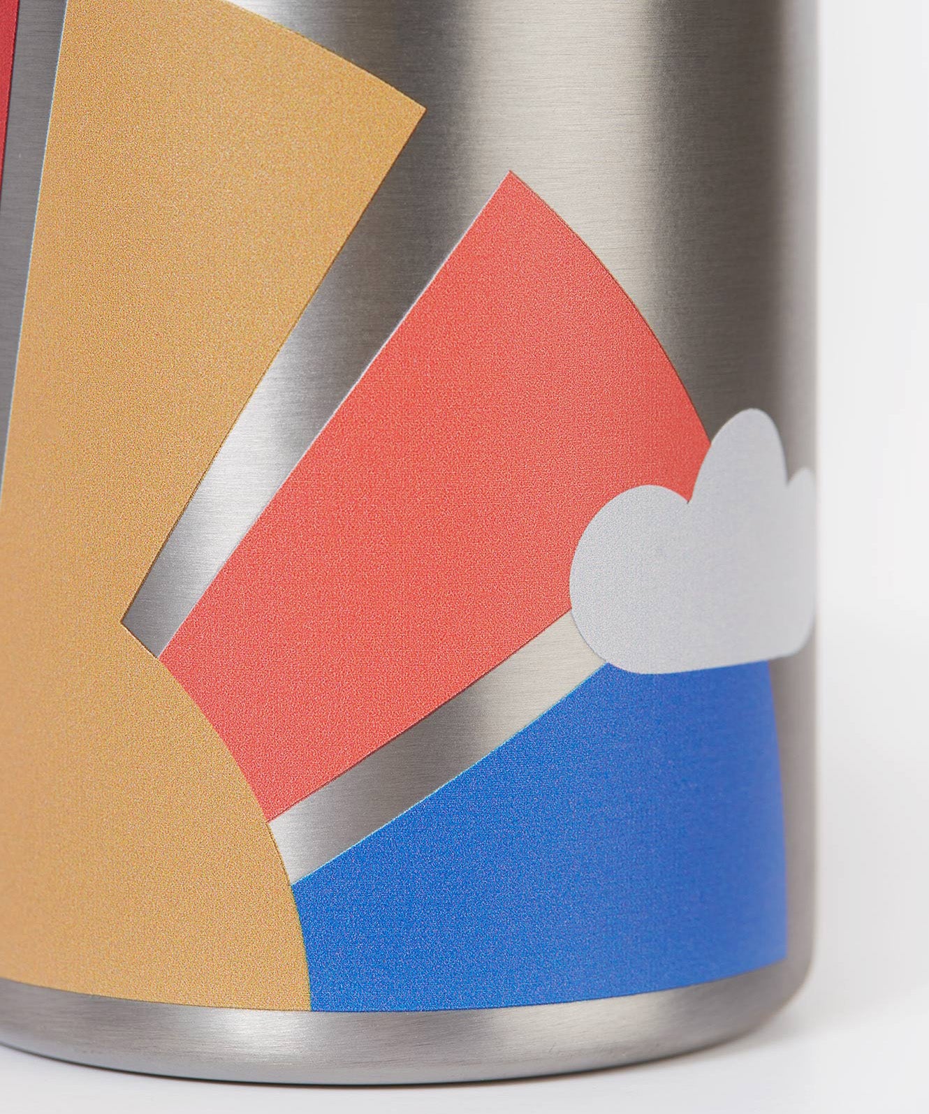 A close up of the Frugi kids Insulated bottle showing the print of a sun with rainbow rays on the stainless steel bottle
