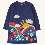 Frugi kids kari dress in navy/rainbow available at Babipur. A 100% GOTS organic cotton long sleeve dress in navy with a playful woodland inspired print on the front.