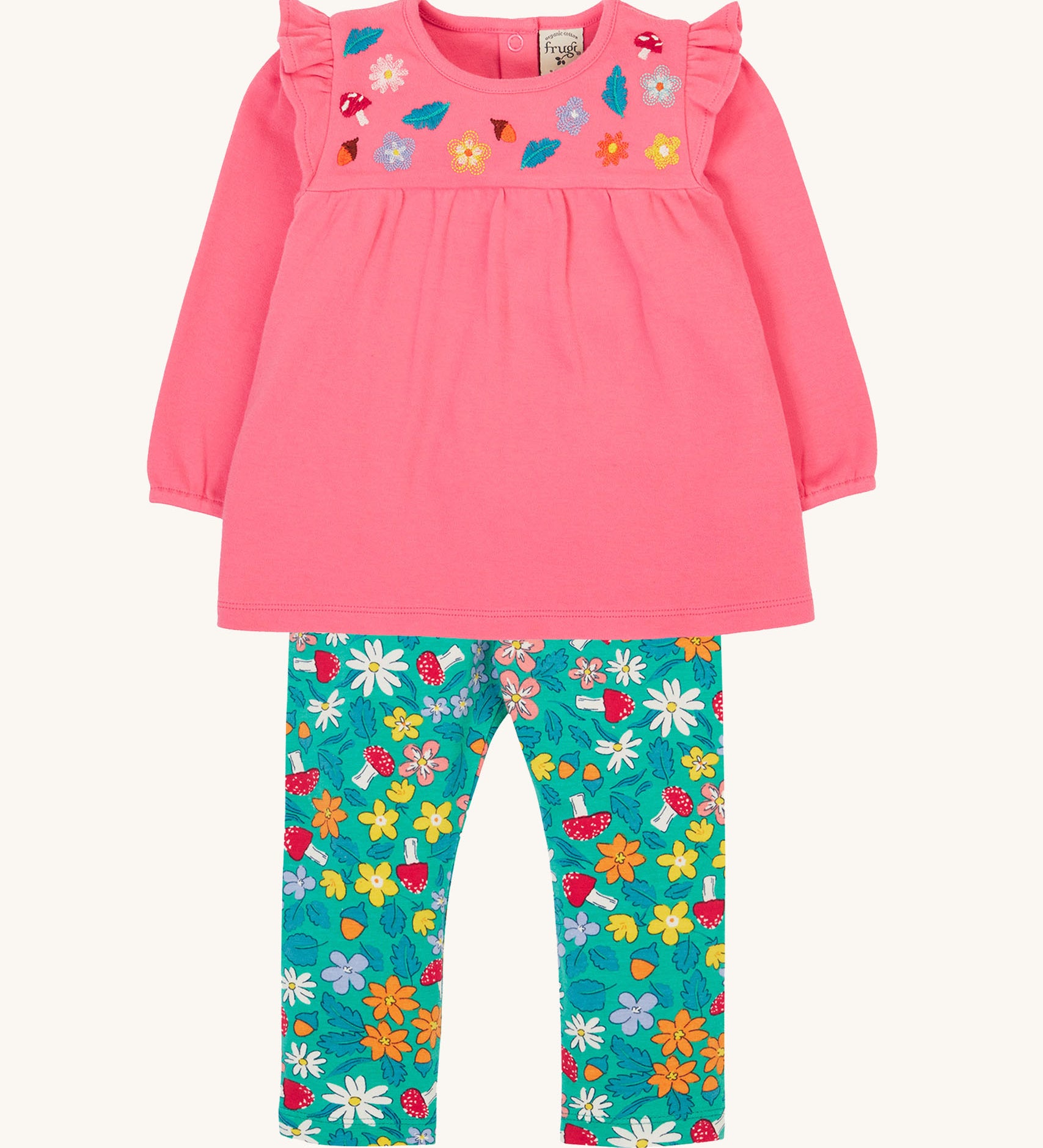 Frugi kids kyla outfit in tulip/wild woods available at Babipur. A GOTS organc cotton outfit which features a pink top with frilled shoulders and turquoise bottoms with woodland inspired prints