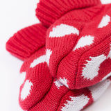 A close up of the Frugi kids noa knitted booties in red mushroom showing the red and white soft knit detail. 