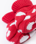 A close up of the Frugi kids noa knitted booties in red mushroom showing the red and white soft knit detail. 