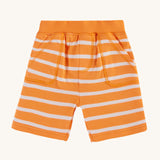 Frugi Organic Little Ellis Shorts - Tangerine Breton Stripe. A super soft organic cotton shorts in bright tangerine orange and white Breton stripes, and a comfy elasticated waistband with two handy pockets, on a cream background