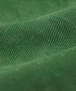A close up of the cord material on the Frugi Kids' Organic Cotton Corduroy Trousers in a Holly Green colour