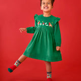 Child wearing the Frugi organic cotton maud holly green corduroy dress with embroidery robin details on the chest and shoulder frills with robin socks.
